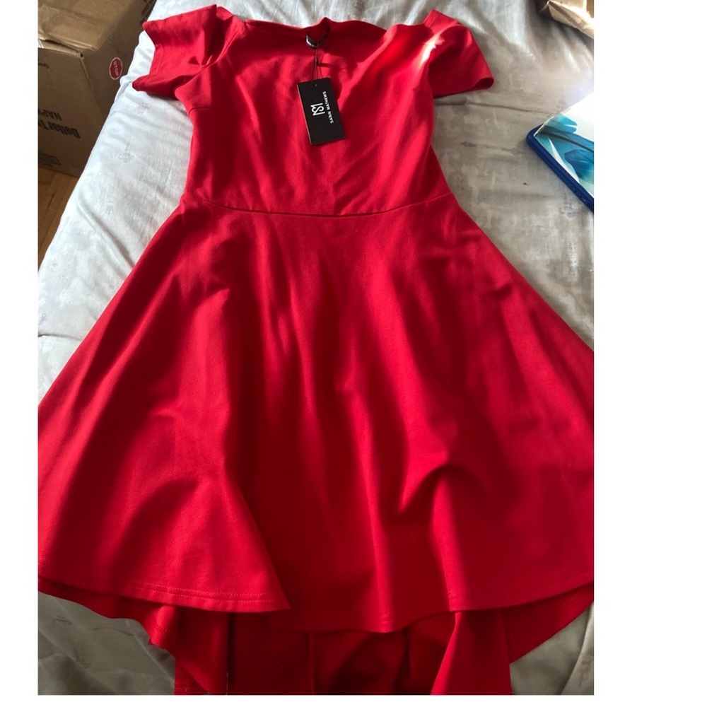 Brand new worn once red shirt in the front long short tail in the back